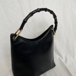 Vintage Gucci Bamboo bag with black handle and gold hardware.