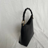 Vintage Gucci Bamboo bag with black handle and gold hardware.