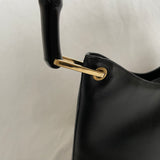 Vintage Gucci Bamboo bag with black handle and gold hardware.