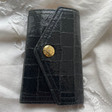 Miu Miu key wallet in black leather. Shows minor signs of wear on the hardware, but overall in very good condition