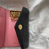 Miu Miu key wallet in black leather. Shows minor signs of wear on the hardware, but overall in very good condition