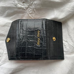 Miu Miu key wallet in black leather. Shows minor signs of wear on the hardware, but overall in very good condition