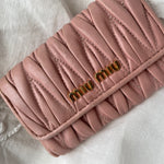 Miu Miu wallet in soft pink leather with a signature matelassé pattern.