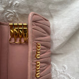 Miu Miu wallet in soft pink leather with a signature matelassé pattern.