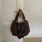 This is a Celine Macadam Bitter Sweet handbag, showcasing the brand's iconic macadam pattern. The bag features a combination of brown canvas and croc-embossed leather details, accentuated by gold-tone hardware.&nbsp;