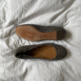 Coach woven leather ballet flats in grey with a subtle silver edge. They’re in excellent condition and show little to no signs of visible wear.