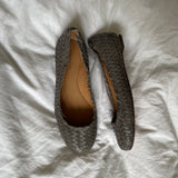 Coach woven leather ballet flats in grey with a subtle silver edge. They’re in excellent condition and show little to no signs of visible wear.