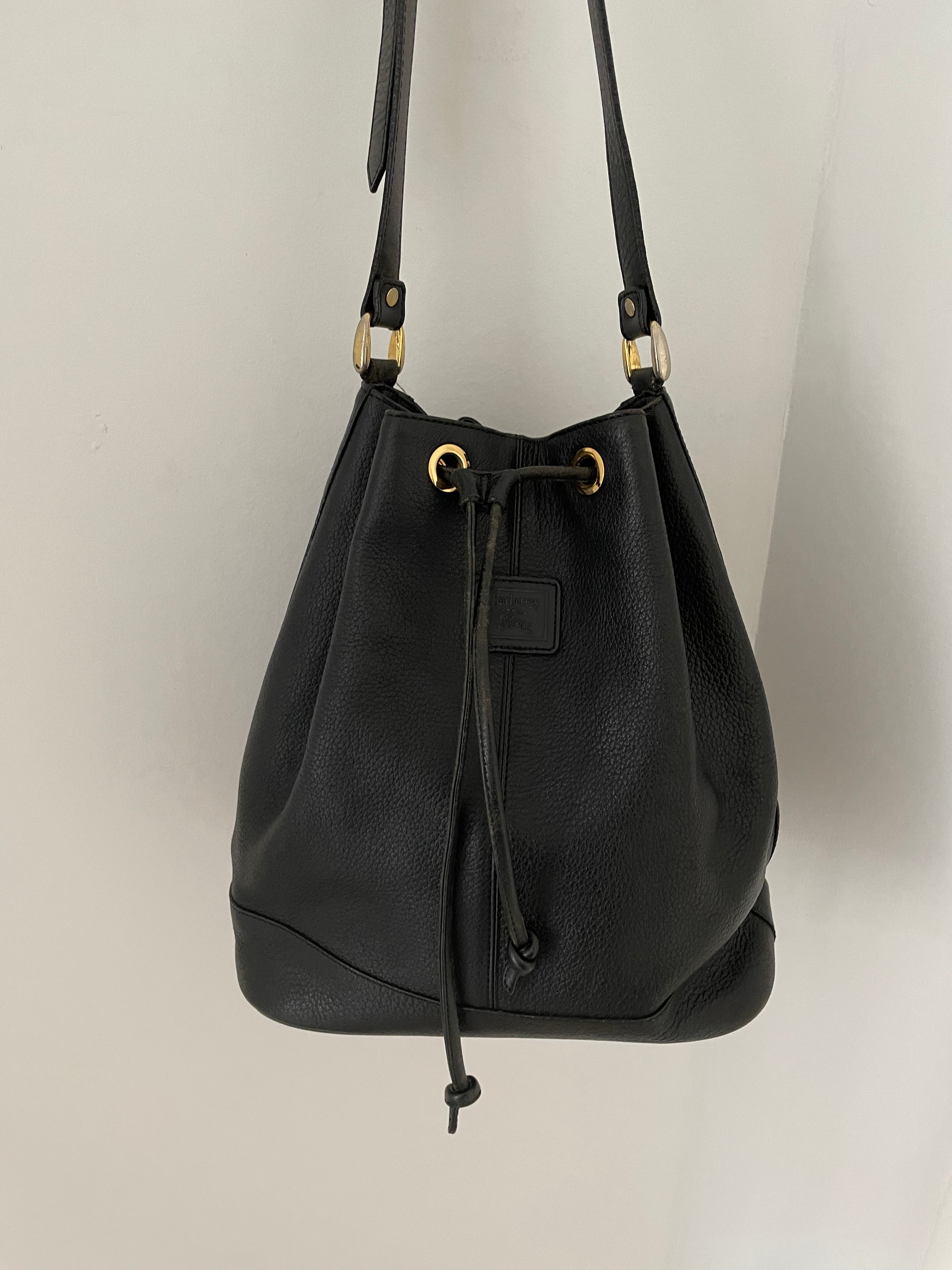 Vintage Burberrys bucket bag featuring signature canvas in the interior. The bag is overall in a good condition but the leather strap show signs of wear.&nbsp;