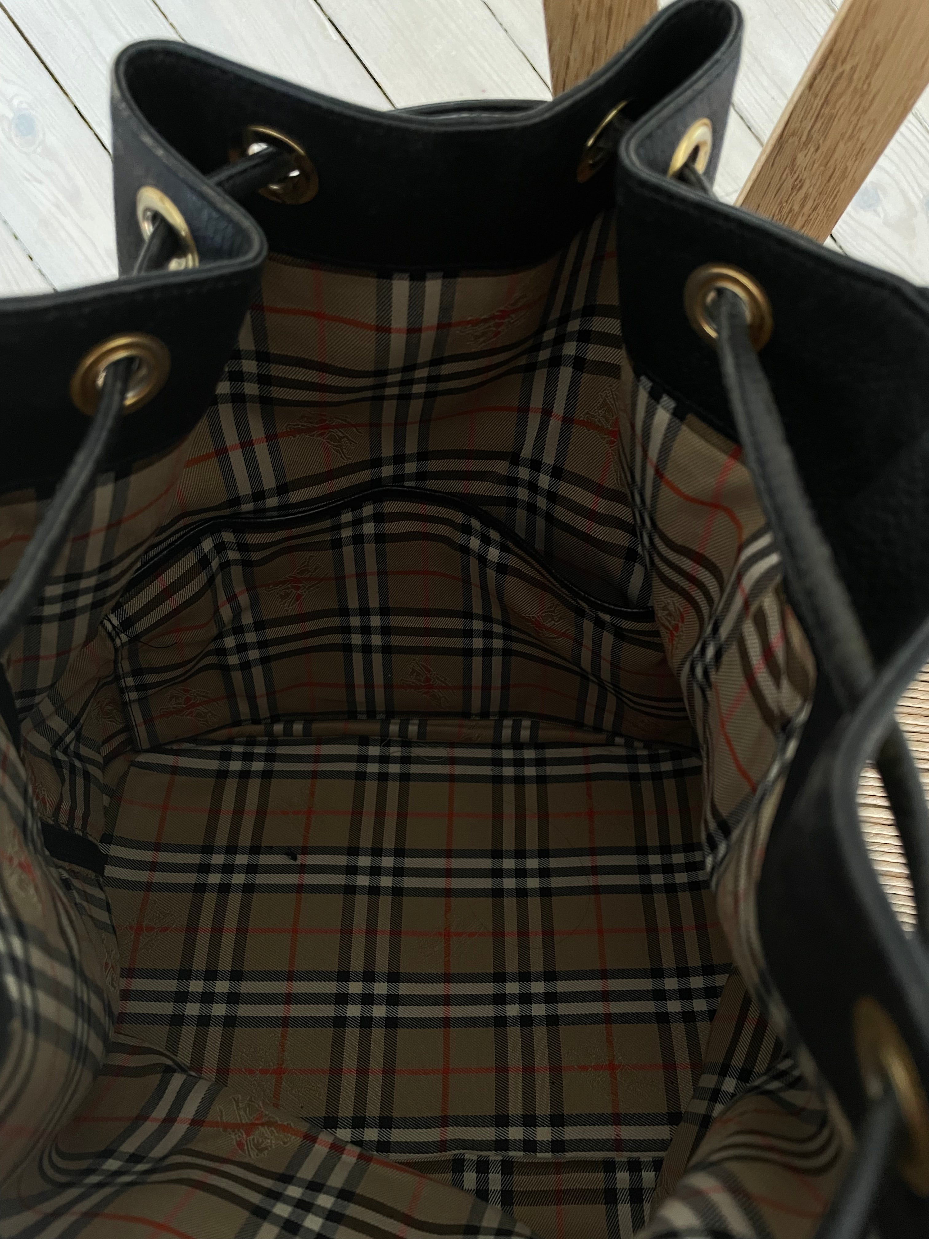 Vintage Burberrys bucket bag featuring signature canvas in the interior. The bag is overall in a good condition but the leather strap show signs of wear.&nbsp;